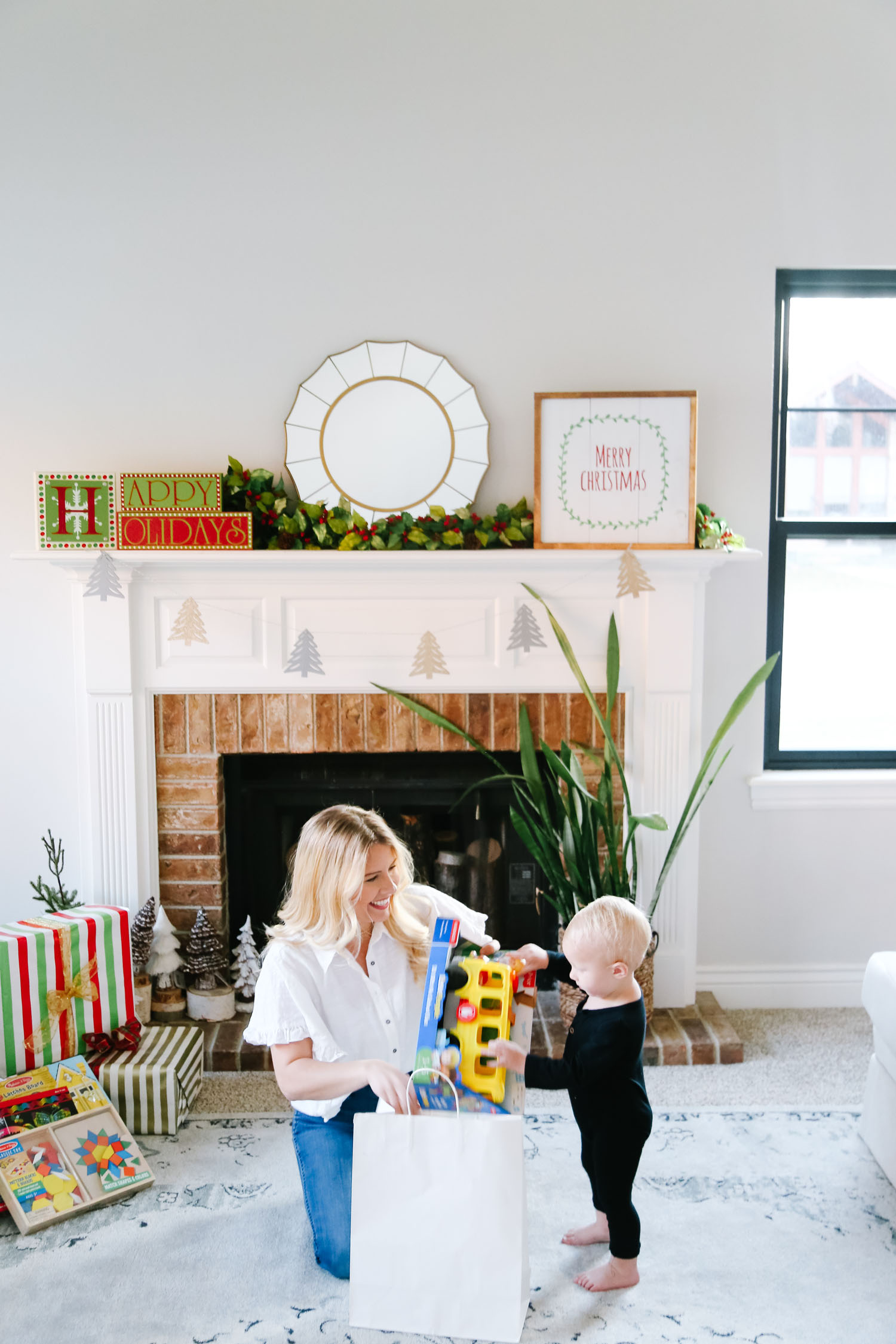 The Best Kohl's Toys your Children will Love, featured by Utah life and style blogger, By Jen Rose: image of a toddler wrapping a Kohl's toy with her mom