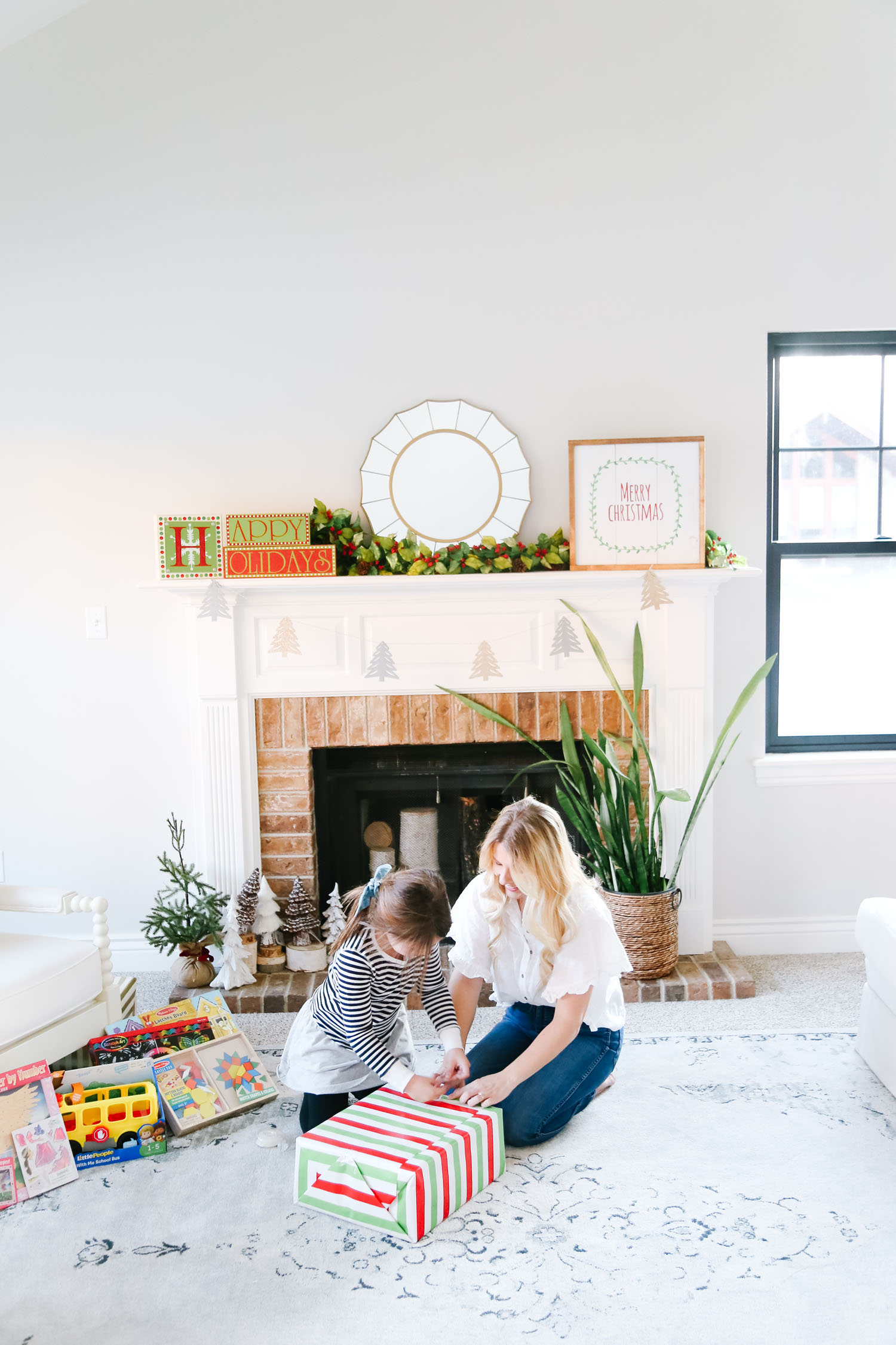 The Best Kohl's Toys your Children will Love, featured by Utah life and style blogger, By Jen Rose: image of a girl wrapping a Kohl's toy with her mom