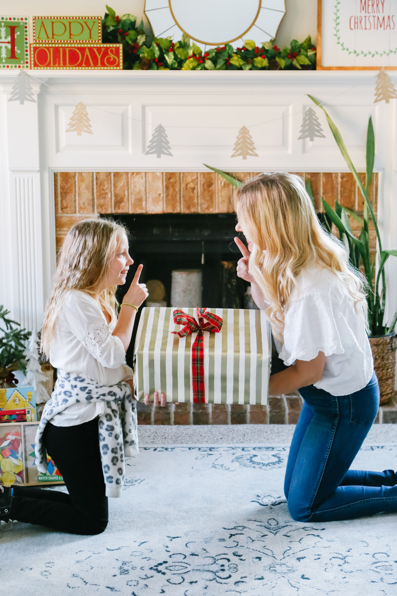 The Best Kohl's Toys your Children will Love, featured by Utah life and style blogger, By Jen Rose: image of a girl wrapping a Kohl's toy with her mom