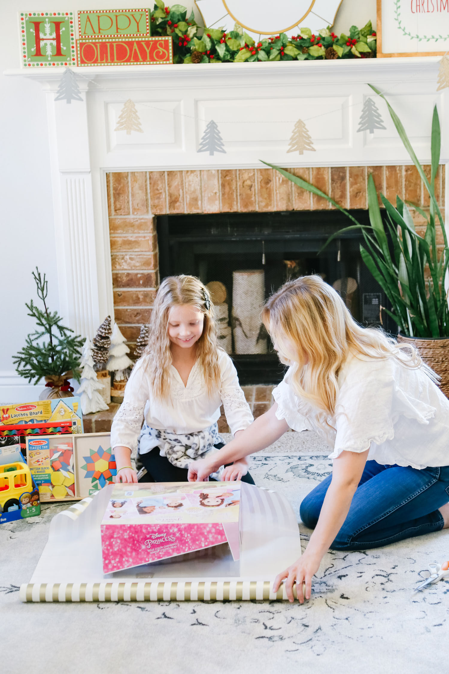 The Best Kohl's Toys your Children will Love, featured by Utah life and style blogger, By Jen Rose: image of a girl wrapping a Kohl's toy with her mom
