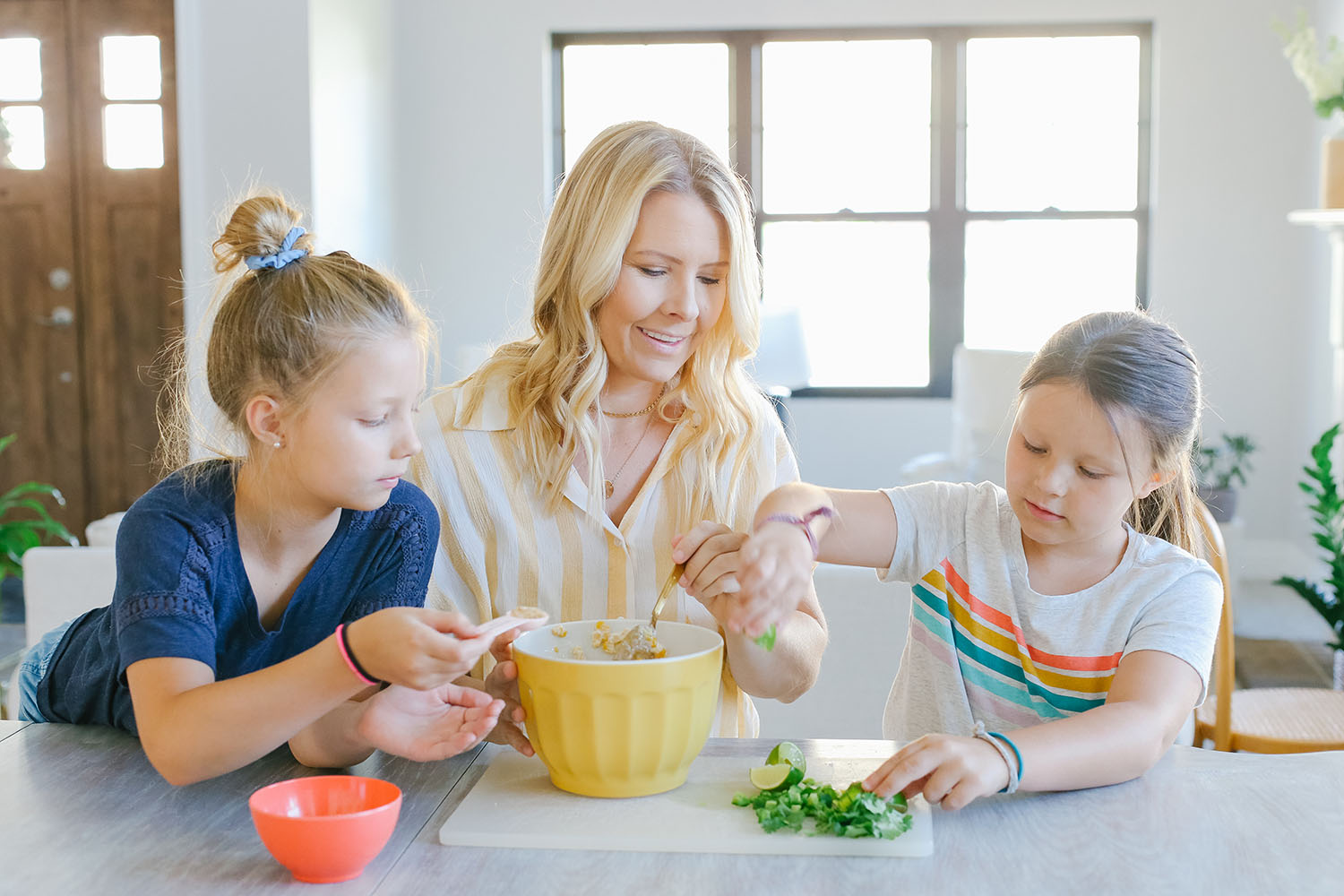Tips for Hosting a Simple Summer Dinner Party featured by US lifestyle blogger, By Jen Rose: image of a mom making salsa with her daughters