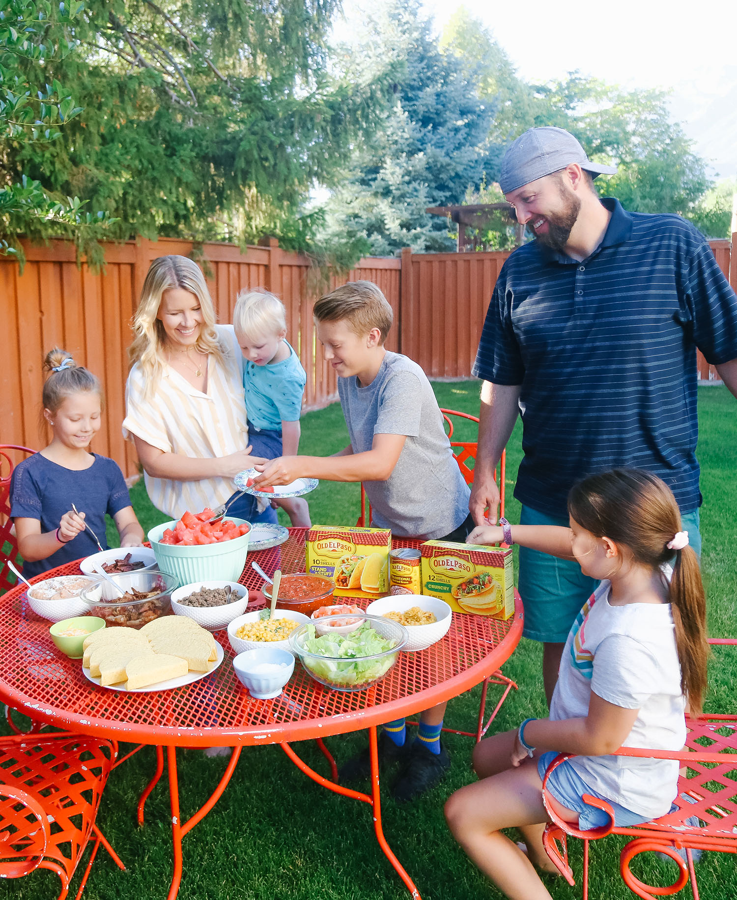 Tips for Hosting a Simple Summer Dinner Party featured by US lifestyle blogger, By Jen Rose: image of a family at their summer dinner party